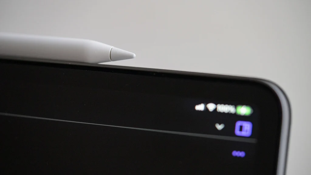 Close-up of an Apple Pencil resting along the edge of an iPad Pro