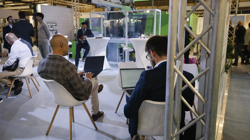 Business professionals using laptops during a conference event