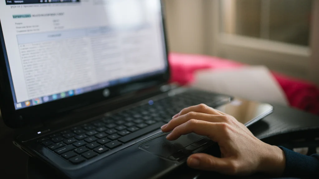 Real person using a laptop for everyday work in a bright indoor setting