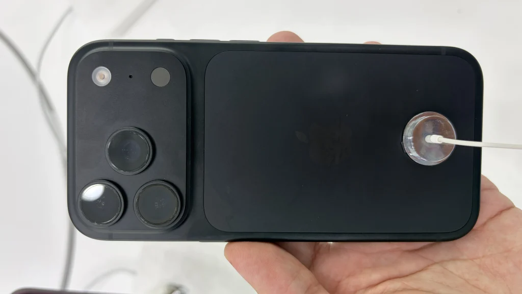 Real black iPhone 18 Pro held in a hand with its three rear cameras visible
