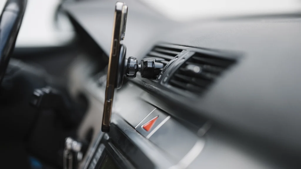 Real smartphone secured to a dashboard mount inside a modern car